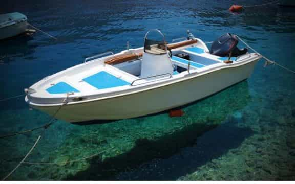 Small fishing boat tied to dock.